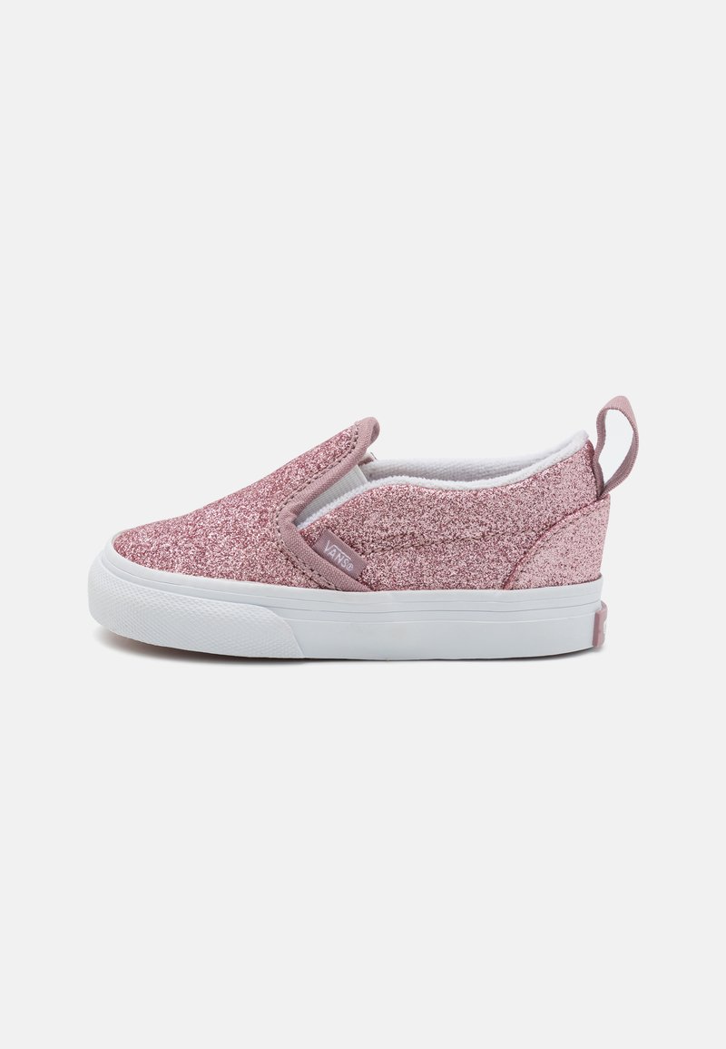 Rozā mirdzoši auduma slip-on tenisa apavi ar baltu gumijas zoli. Elastīgas sānu aksesuāri ērtai uzvilkšanai un kontrastējošs rozā papēža ieraksts.
