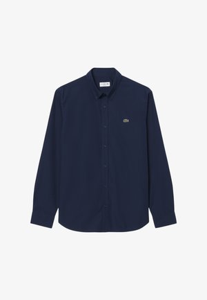 Marineblauw overhemd met lange mouwen, knoopsluiting, knoopkraag en een klein groen krokodillenlogo op de linkerborst.