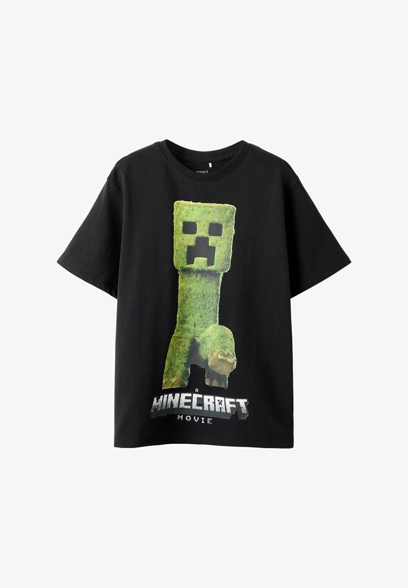 T-shirt in cotone nero con un grande personaggio cubico verde con espressione contrariata e artigli, il testo stampato sotto recita "Un film di Minecraft."