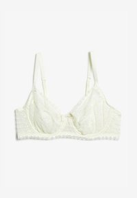 Bralette de encaje en color blanco roto que presenta copas transparentes, correas ajustables y un ribete ondulado con un pequeño lazo en el centro.