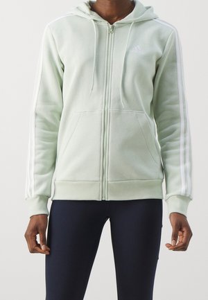 Zippered hoodie in light green cotton blend, featuring white shoulder stripes, a lined hood, front pockets, and ribbed cuffs and hem.