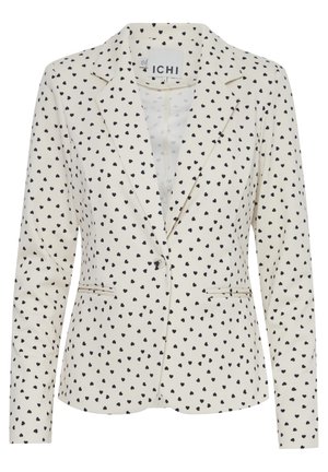 Blazer aus cremefarbenem Stoff mit einem gepunkteten schwarzen Herzmuster. Verfügt über einen Reverskragen, zwei frontale Taschen und einen einzigen Knopfverschluss.