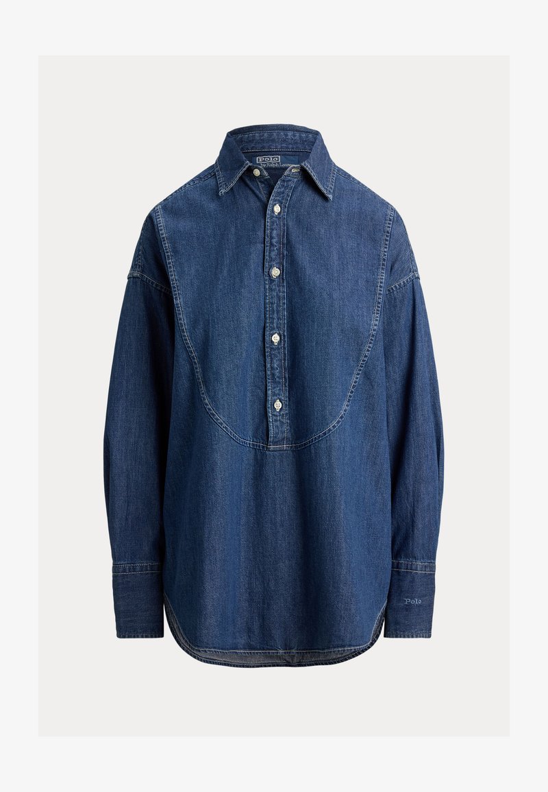 Camicia di denim di colore blu scuro, con chiusura frontale con bottoni, colletto a punta, maniche lunghe e dettaglio unico con yoke curvo sul retro.