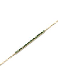 Gold bracelet featuring a row of green gemstones set in a sleek, linear design, with a delicate chain extending from each end.
