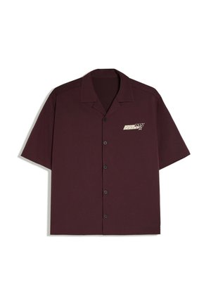 Chemise boutonnée à manches courtes bordeaux foncé avec col et petit logo blanc sur la poitrine gauche indiquant "Big Boss Max Design."