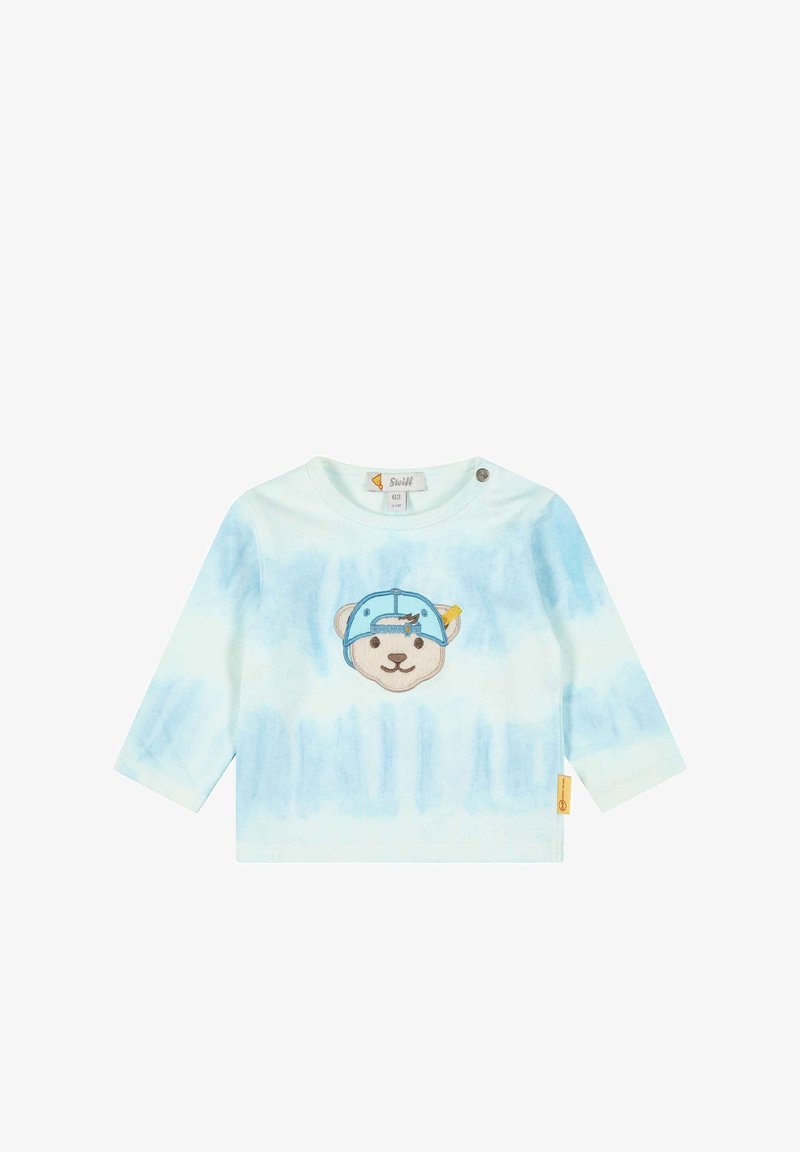 Světle modrá košile s dlouhým rukávem, která má graphic medvěda s čepicí. Vyrobena z měkké bavlny s jemným tie-dye vzorem a podpínacím knoflíkem na rameni.