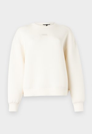 Mikina krémovej farby vyrobená z jemnej látky, s okrúhlym výstrihom, spustenými ramenami a jednoduchým prešitím na manžetách a leme.