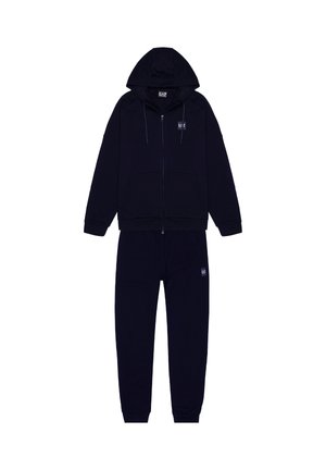 Navyblauwe zip-up hoodie met trekkoorden, zijzakken en bijpassende joggingbroek. Gemaakt van zachte stof met een logo patch op de borst en het been.
