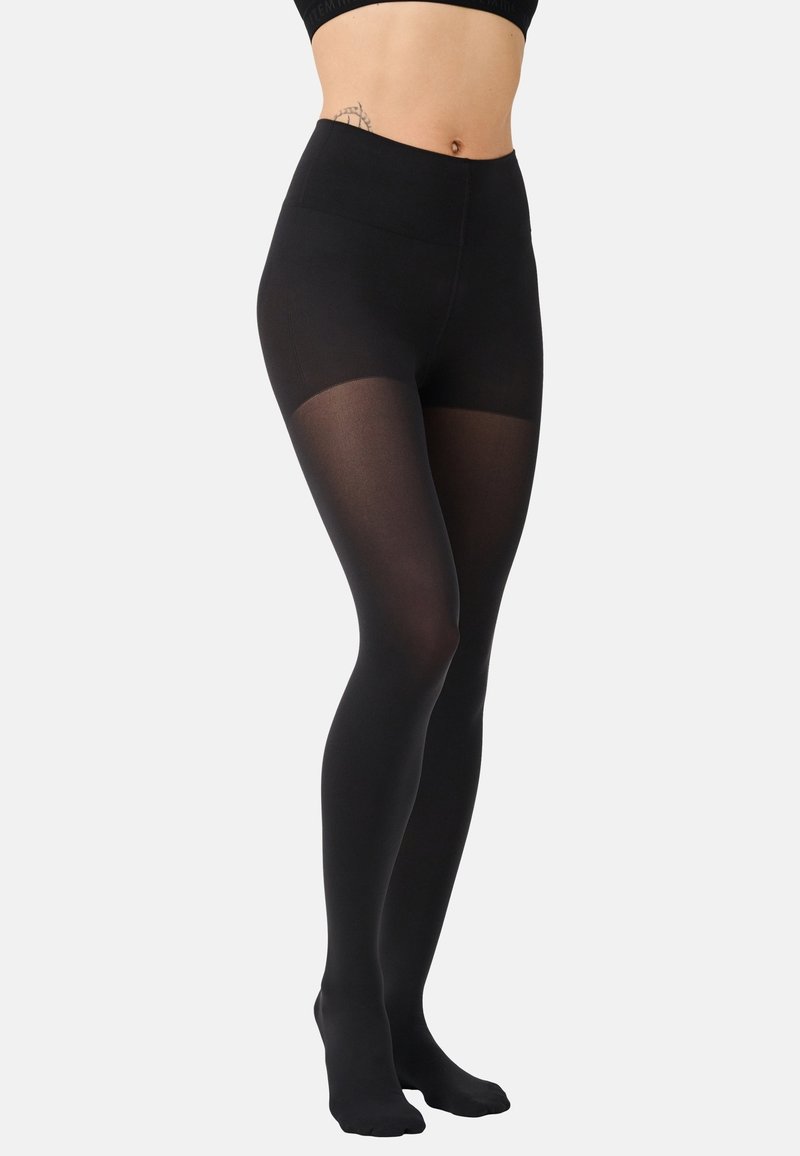 Leggings opaques noires avec une taille haute et une texture lisse, se transformant en une section transparente au niveau du bas de la jambe.