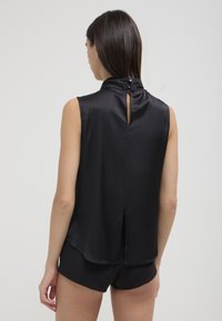 Calliope SMANICATA CON FIOCCO  - Top - nero