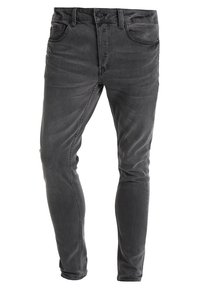 Slim fit svarta denimjeans med lätt blekning, med två framfickor, en myntficka och två bakfickor med detaljerade sömmar.