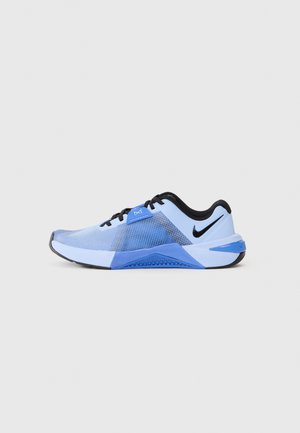 Blue athletic shoe with a mesh upper, black accents, textured sole, and dynamic design featuring gradient patterns along the side.