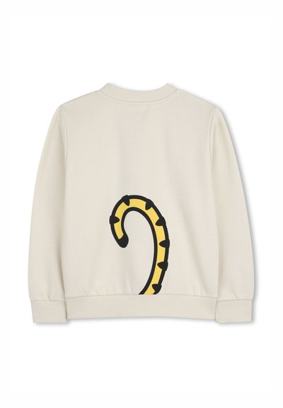 Felpa color crema con un design di coda nero e giallo sulla schiena. Polsini e collo a coste completano l'aspetto casual.