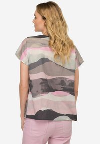Blusa a maniche corte in tessuto leggero con motivi astratti nelle tonalità di grigio, rosa e verde; vestibilità ampia con scollatura a barca.