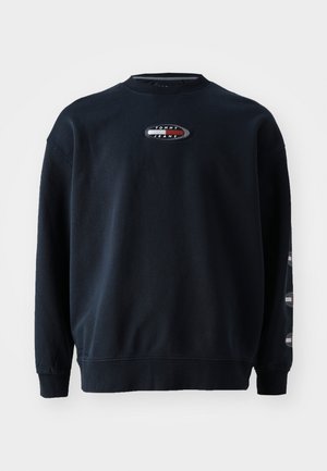 Mørkeblå crewneck sweatshirt med ribstrikkede manchetter og kant, med lille ovalt Tommy Jeans-logo på bryst og ærme.