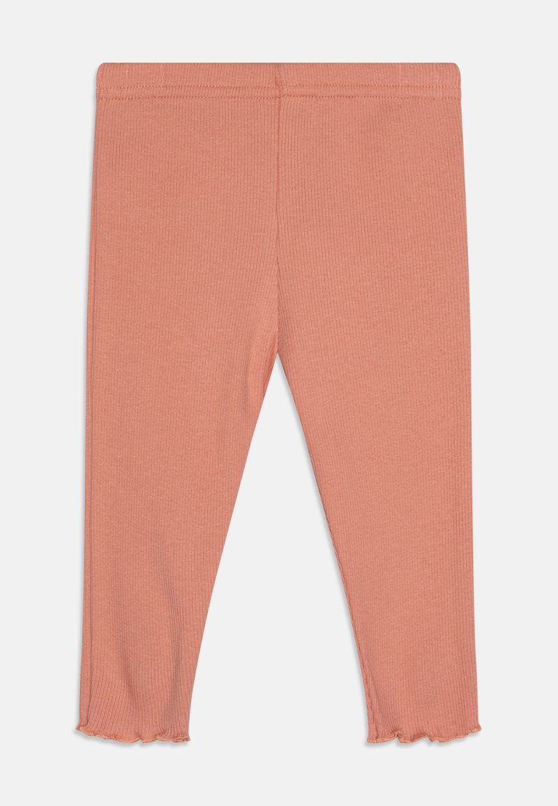 Leggings roses à côtes avec une coupe ajustée, dotés d'un ourlet volanté et d'une taille élastique pour le confort. Texture de tissu douce.