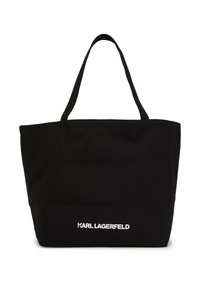 Svart canvas axelväska med två axelremmar och en vit "KARL LAGERFELD"-logotyp längst ned, med en enkel rektangulär design.