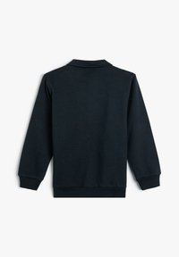 Czarny longsleeve z nadrukiem, z ribbowymi mankietami i dolnym obszyciem, prezentowany od tyłu na białym tle.