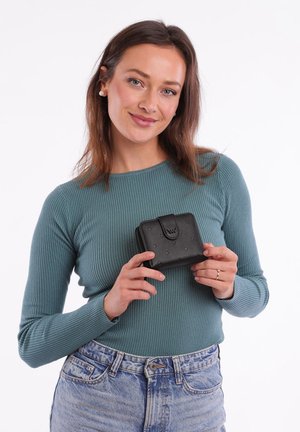 Black textured wallet with raised dot pattern, zip closure, and snap button. Held in hands against a plain background.