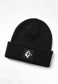 Black ribbed knit beanie featuring a folded cuff and a square patch with a white wolf graphic on a black background.