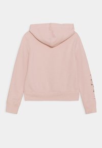 Sudadera rosa con capucha, diseño cropped, puños acanalados y bordado floral en la manga izquierda. Tejido suave y estilo minimalista.