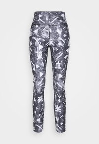 Leggings à motif noir et blanc avec une taille haute. Présentent des formes géométriques et des designs abstraits sur un tissu texturé.