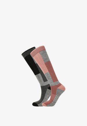 Knæhøje sokker i sort, grå og pink med et geometrisk mønster. Materialet virker blødt, ribbet top og kontrasterende farveafsnit.