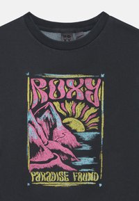 Svart sweatshirt med en färgglad grafisk design av berg och en sol, med texten "ROXY PARADISE FOUND" i rosa och gult.