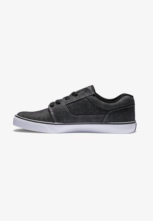 Black denim sneakers with a low-profile design, white rubber sole, and black laces. Features a textured finish and contrasting seams.