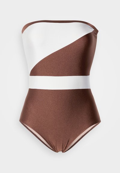 Barna-fehér egyrészes fürdőruha pánt nélküli kialakítással. Sima, fényes textúrával és átlós színblokkoló mintával.