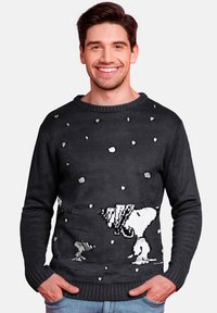 Black knitted sweater featuring a Snoopy design with white accents, depicting snowflakes, with a ribbed neckline and cuffs.