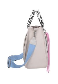 Light gray canvas bag with a structured shape, featuring black and white patterned straps, a blue adjustable shoulder strap, and pink tassels.