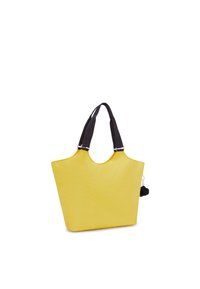Gul totebag med en slät, matt yta, bred öppning och svarta textilhantag. Har en dekorativ svart pom-pom fäst.