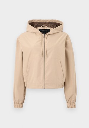 Cropped beige jacket made of a smooth, lightweight material. Features a hood, zip closure, and elastic wrist cuffs. Two front pockets.