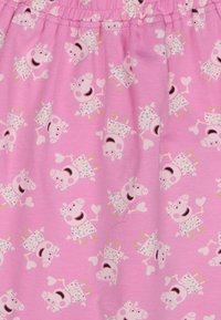 Tejido de algodón rosa con un patrón repetido de cerdos de dibujos animados en vestidos, sonriendo y sosteniendo corazones, con detalles coloridos.