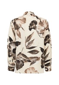 Chemise à manches longues à motif floral en crème, ornée de fleurs brun foncé et beige, fabriquée en tissu léger avec une coupe décontractée.