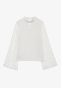 White top featuring a high neckline with a keyhole opening, soft fabric on the body, and pleated, textured fabric on the sleeves.
