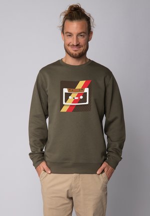 Olive green sweatshirt featuring a retro cassette tape graphic in white, brown, and red, with a relaxed fit and ribbed cuffs and hem.