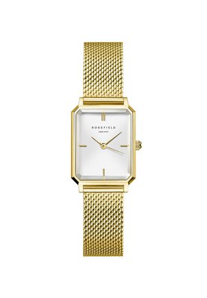 Montre avec un bracelet en maille dorée, dotée d'un cadran rectangulaire blanc, avec des marqueurs d'heure et des aiguilles noires, et une lunette dorée octogonale.