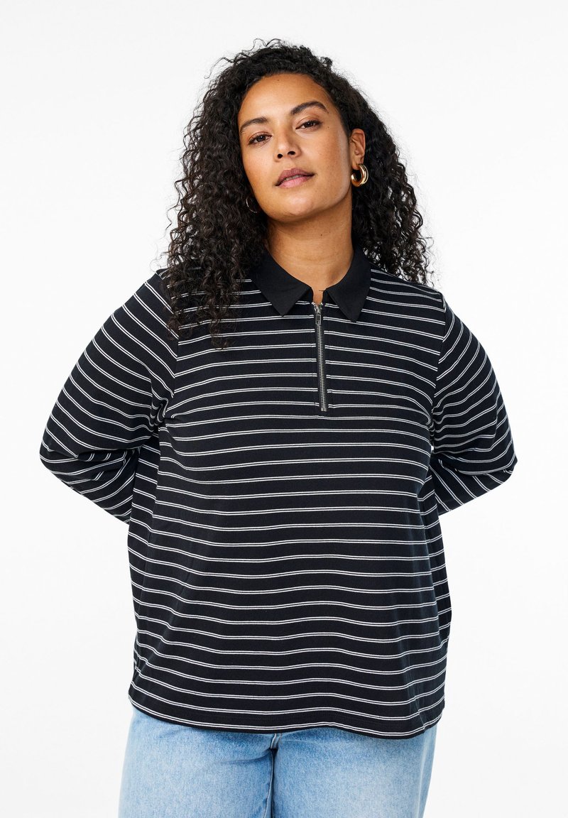 Mustat ja valkoiset raidalliset polo-paidat, joissa on vetoketjuneckline ja lyhyet hihat, valmistettu pehmeästä kankaasta. Pyöreä helma, jossa on hieman venyvyyttä.