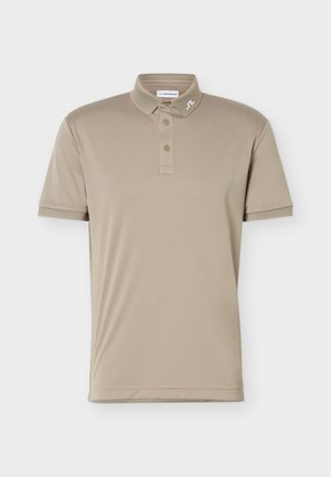 Polo beige a maniche corte con abbottonatura a tre bottoni e piccolo logo bianco sul colletto, mostrata su sfondo bianco uniforme.