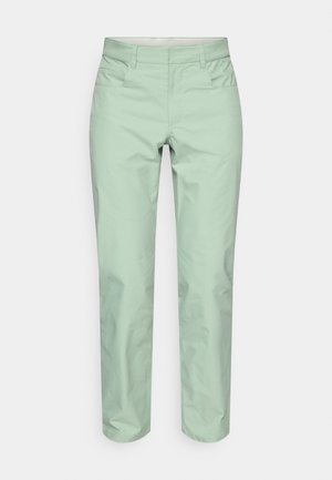 Šviesiai žalsvos, pritaikytos kelnės su lygiu paviršiumi, priekinių kišenių, diržo kilpų ir tiesių kojų dizainu. Minimalistinio stiliaus, be matomų raštų.