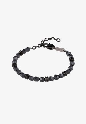 Bracelet en perles facettées noires avec des séparateurs ronds et un fermoir à chaîne ajustable, arborant une petite étiquette rectangulaire gravée "BREIL".