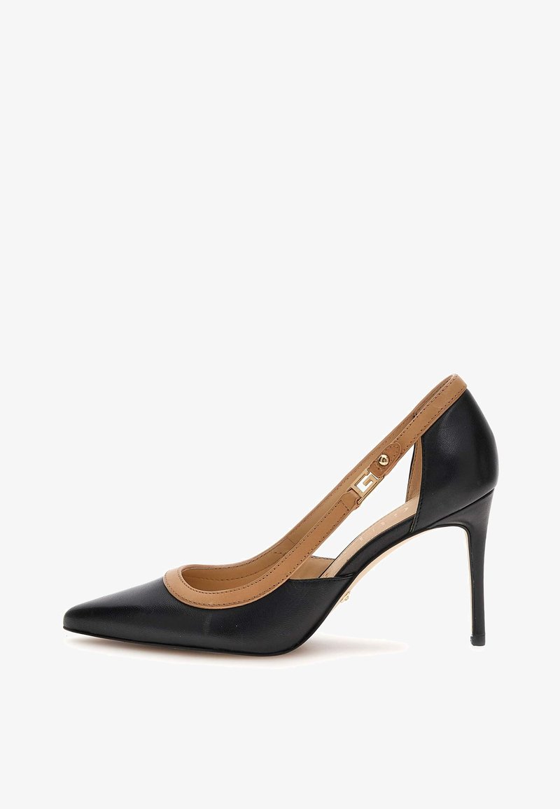 Black leather pump with pointed toe and tan accents. Features a cutout side design, slender high heel, and a gold-tone hardware detail.
