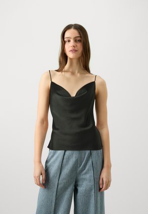 Black satin camisole with thin straps and a V-neckline, featuring a smooth texture and a fitted shape. Worn with light blue pleated trousers.