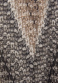 Abstrakti kangaspala, joka yhdistää beigen, ruskean ja mustan sävyjä ja siinä on tekstuurinen kuvio, joka muistuttaa eläinkuosia.