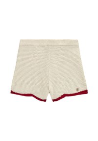 Stickade shorts i grädde med ett strukturerat mönster, med en röd nederdel och en liten logotypdetalj på sidan.
