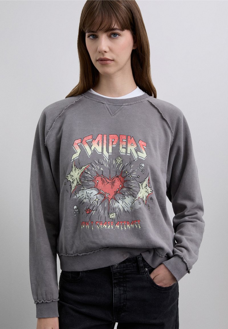 Grey sweatshirt with a distressed texture, featuring a colorful graphic design of a heart and text "SCAPERS" and "DON'T CHASE ATTRACT."
