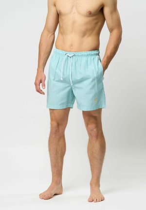 Hellblaue Schwimmshorts mit einem weißen Karomuster. Elastischer Bund mit Kordelzug. Gelbes Logo unten links. Weicher Stoff.
