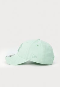 Casquette de baseball vert clair en coton, avec des détails de logo brodés, visière incurvée et des trous de ventilation sur les côtés.